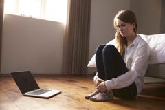 Unhappy Young Woman Being Bullied Online With Laptop royalty free stock images Unhappy Young Woman Being Bullied Online With Laptop royalty free stock images