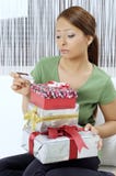Unhappy young woman with gift boxes royalty free stock photography Unhappy young woman with gift boxes royalty free stock photography