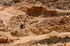 Unidentified local man collects clay for building houses. stock photography Unidentified local man collects clay for building houses. stock photography