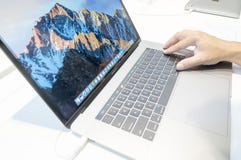 Unidentified man using new Apple Macbook Pro. KUALA LUMPUR, MALAYSIA-JANUARY 15,2017: Unidentified man using new Apple Macbook Pro computer at shopping mall Stock Photography Unidentified man using new Apple Macbook Pro. KUALA LUMPUR, MALAYSIA-JANUARY 15,2017: Unidentified man using new Apple Macbook Pro computer at shopping mall Stock Photography