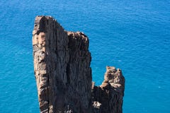 Rock formation in front of the blue ocean. Unique rock formation in front of the blue sea in the sunshine Stock Photos Rock formation in front of the blue ocean. Unique rock formation in front of the blue sea in the sunshine Stock Photos