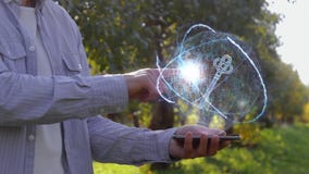 Unrecognizable man shows conceptual hologram with key
