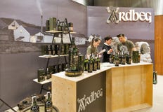 Whisky Dram Festival in Kiev, Ukraine. Unrecognized presenters work on Ardbeg Single Malt peated Scotch Whisky distillery booth at 3rd Ukrainian Whisky Dram stock image Whisky Dram Festival in Kiev, Ukraine. Unrecognized presenters work on Ardbeg Single Malt peated Scotch Whisky distillery booth at 3rd Ukrainian Whisky Dram stock image