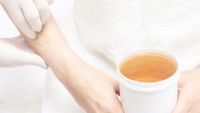 Unwanted hair wax epilation. Young Woman. cosmetology salon treatment procedure. Home waxing stock photos Unwanted hair wax epilation. Young Woman. cosmetology salon treatment procedure. Home waxing stock photos