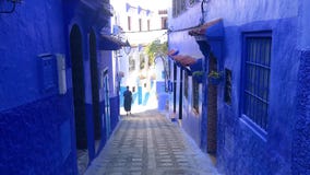 Uomini che camminano in via del Medina blu della città Chefchaouen nel Marocco archivi video Uomini che camminano in via del Medina blu della città Chefchaouen nel Marocco archivi video