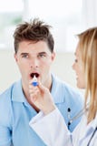 Uomo bello con il suo medico che cattura temperatura immagine stock Uomo bello con il suo medico che cattura temperatura immagine stock