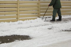 Uomo in neve di pulizia uniforme con una pala fotografia stock libera da diritti Uomo in neve di pulizia uniforme con una pala fotografia stock libera da diritti