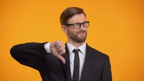 Upset businessman showing thumbs down, unprofitable investment, unemployment stock footage Upset businessman showing thumbs down, unprofitable investment, unemployment stock footage