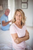 Upset senior couple arguing in bedroom Royalty Free Stock Images Upset senior couple arguing in bedroom Royalty Free Stock Images