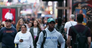 Urban Crowd of Anonymous commuters, unrecognizable tourists  walking in Manhattan, NYC. Times Square. Blurry Background. XV