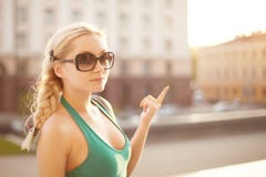 Urban portrait of stylish happy model blonde girl in green dress and sunglasses with hair plaited in a braid posing at royalty free stock images Urban portrait of stylish happy model blonde girl in green dress and sunglasses with hair plaited in a braid posing at royalty free stock images