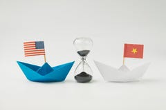 US and China financial trade war tariff strategy concept, hourglass / sandglass at the center between blue paper ship with
