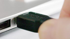 USB 3.0 cable connector being plugged into computer stock video