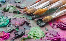 used brushes in an artist's palette of colorful oil paint for dr royalty free stock photography used brushes in an artist's palette of colorful oil paint for dr royalty free stock photography