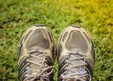 Used sport shoes on yard background stock image Used sport shoes on yard background stock image