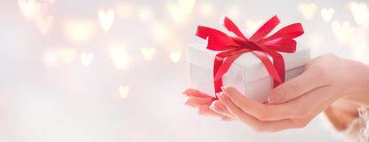 Valentine`s Day. Woman holding gift box with red bow Stock Photos Valentine`s Day. Woman holding gift box with red bow Stock Photos