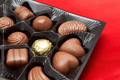 Valentines chocolates in box on red silk Stock Photos Valentines chocolates in box on red silk Stock Photos