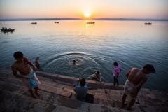 Dawn on Ganges river, with silhouettes of boats with pilgrims. stock photos Dawn on Ganges river, with silhouettes of boats with pilgrims. stock photos