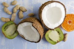 Fresh healthy veg food.Coconut,peanuts,kiwi fruit,orange on blue background stock photos Fresh healthy veg food.Coconut,peanuts,kiwi fruit,orange on blue background stock photos