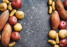 Variety Of Raw Uncooked Organic Potatoes: Red, White, Sweet And Fingers Potatoes Over Dark Texture Background Stock Photos