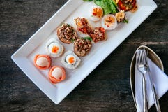 Asian canapes appetizer - Smoked salmon, maki, larb, tuna tartar stock photo Asian canapes appetizer - Smoked salmon, maki, larb, tuna tartar stock photo