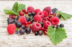 Various berries on an old wooden plank close-up Stock Photos Various berries on an old wooden plank close-up Stock Photos