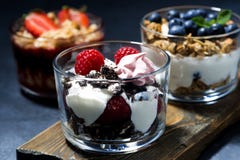 Various Desserts With Fresh Berries And Cream On Dark Background Stock Photo