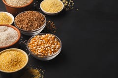 Various gluten free groats on black background with copy space. Assortment of gluten free grains in bowls on black background, copy space stock photo Various gluten free groats on black background with copy space. Assortment of gluten free grains in bowls on black background, copy space stock photo
