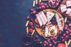 Various snacks-fruit, cheese,sausage, red wine. Top view, copy space. Toned photo. royalty free stock photography Various snacks-fruit, cheese,sausage, red wine. Top view, copy space. Toned photo. royalty free stock photography