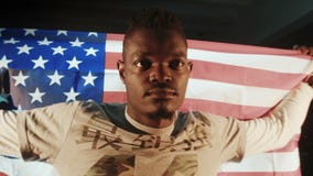 Varón afroamericano con la bandera americana en manos almacen de video Varón afroamericano con la bandera americana en manos almacen de video
