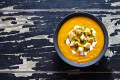 Vegetable cream soup with carrot and pumpkin. Top view on a dark creative background. Healthy diet meal. stock photo Vegetable cream soup with carrot and pumpkin. Top view on a dark creative background. Healthy diet meal. stock photo