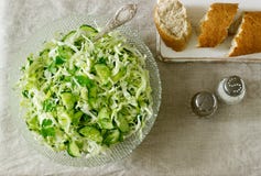 Vegetable salad of fresh cabbage, cucumber and onion with parsley and dill. Rustic style. royalty free stock image Vegetable salad of fresh cabbage, cucumber and onion with parsley and dill. Rustic style. royalty free stock image