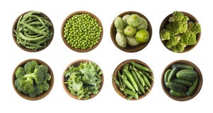 Vegetables isolated on a white. Squash, green peas, broccoli, kale leaves and green bean in wooden bowl. Vegetables with copy spac