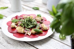 Vegetarian carpaccio of roasted beetroot with cauliflower and green salad royalty free stock images Vegetarian carpaccio of roasted beetroot with cauliflower and green salad royalty free stock images