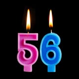 Velas ardientes del cumpleaños bajo la forma de 56 cincuenta y seis para la torta aislada en fondo negro imagen de archivo libre de regalías Velas ardientes del cumpleaños bajo la forma de 56 cincuenta y seis para la torta aislada en fondo negro imagen de archivo libre de regalías
