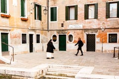 Venice, Italy - March 11, 2012: Two women going on ancient street in Venice stock photo Venice, Italy - March 11, 2012: Two women going on ancient street in Venice stock photo
