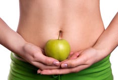 Ventre sportif avec la pomme chez les mains de la femme image stock Ventre sportif avec la pomme chez les mains de la femme image stock