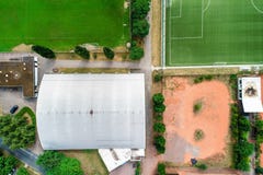 Vertical aerial view of a tennis hall next to a green football pitch with grass in front of a red ash field in Wolfsburg, Germany stock image Vertical aerial view of a tennis hall next to a green football pitch with grass in front of a red ash field in Wolfsburg, Germany stock image