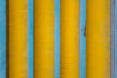 Vertical blue lines on a dirty yellow background with shadows. rough surface texture stock photography Vertical blue lines on a dirty yellow background with shadows. rough surface texture stock photography