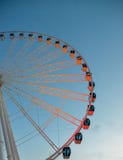 Vertical ferris wheel at dusk illuminated orange, background. stock photo Vertical ferris wheel at dusk illuminated orange, background. stock photo
