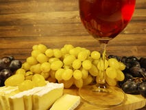 Vetro di vino della natura morta dell'uva, specialità gastronomiche di legno della tavola fotografie stock Vetro di vino della natura morta dell'uva, specialità gastronomiche di legno della tavola fotografie stock