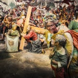 Via Crucis of Jesus Christ, in a Passion of Christ biblical scene a woman show his child a Jesus Christ bringing his cross before stock photography Via Crucis of Jesus Christ, in a Passion of Christ biblical scene a woman show his child a Jesus Christ bringing his cross before stock photography