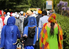 Vicenza, Vi, Italy - April 8, 2017: women with colorful clothes. And veils to cover their heads during the religion festival in city street during stock photography Vicenza, Vi, Italy - April 8, 2017: women with colorful clothes. And veils to cover their heads during the religion festival in city street during stock photography