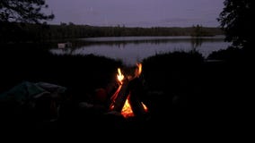 Fire camp beside a lake at night