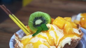 Video Famous Mango shaved ice with ice cream and custard. Tropical fruit cold sweet