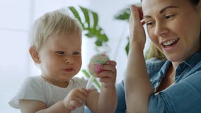 Video of pregnant woman and her cute toddler with lollipop