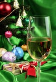 Vidrio de vino blanco en un fondo hermoso de la Navidad foto de archivo libre de regalías Vidrio de vino blanco en un fondo hermoso de la Navidad foto de archivo libre de regalías