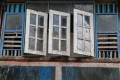 Vieilles et fanées fenêtres bleues et blanches en bois, façade traditionnelle de maison thaïlandaise avec la fenêtre ouverte Photographie stock Vieilles et fanées fenêtres bleues et blanches en bois, façade traditionnelle de maison thaïlandaise avec la fenêtre ouverte Photographie stock