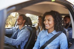 Vier gelukkige jonge volwassen vrienden in een auto op een wegreis stock foto's Vier gelukkige jonge volwassen vrienden in een auto op een wegreis stock foto's