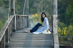 VIETNAM Beautiful women in Ao Dai Vietnam Traditional dress sitting on the wooden bridge this is a Vietnam culture royalty free stock photos VIETNAM Beautiful women in Ao Dai Vietnam Traditional dress sitting on the wooden bridge this is a Vietnam culture royalty free stock photos